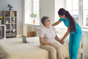 Nurse reviewing medications with an older resident in a bright assisted living apartment.